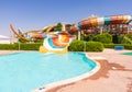 Aquapark pool with colorful striped winding water slides Royalty Free Stock Photo