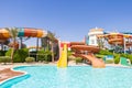 Aquapark pool with colorful striped winding water slides Royalty Free Stock Photo