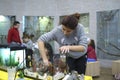 Aquarium husbandry. Girl arranging decorations in an empty aquarium