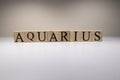 Aquarius word on wooden cubes on white background