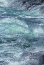 Aquatic background of sea surf waves splashing close up with clear blue green water and white foam Royalty Free Stock Photo