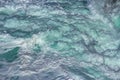 Aquatic background of sea surf waves splashing close up with clear blue green water and white foam Royalty Free Stock Photo