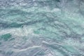 Aquatic background of sea surf waves splashing close up with clear blue green water and white foam Royalty Free Stock Photo