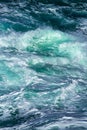 Aquatic background of sea surf waves splashing close up with clear blue green water and white foam Royalty Free Stock Photo