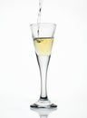 Aquavit pouring in a glass isolated on white background Royalty Free Stock Photo