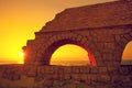 Aqueduct in ancient city Caesarea at sunset