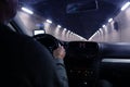 Ar driver driving through a long, dark, lamp-lit tunnel in the Swiss mountains, selective focus on the vehicle dashboard, auto Royalty Free Stock Photo