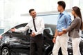 ÃÂ¡ar Salesman Invites Customers at Showroom. Royalty Free Stock Photo