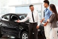 ÃÂ¡ar Salesman Invites Customers at Showroom. Royalty Free Stock Photo