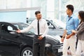 ÃÂ¡ar Salesman Invites Customers at Showroom. Royalty Free Stock Photo