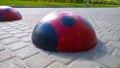 ÃÂ¡ar traffic barrier on pedestrian path as concrete hemispheres like red ladybug. Speed bump. Sleeping policeman. Road safety regu