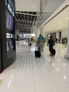 Arab airlines flight attendants in uniform with luggage walk airport building to plane, concept professional flight service,