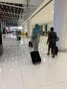 Arab airlines flight attendants in uniform with luggage walk airport building to plane, concept professional flight service,