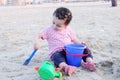 Arab baby girl playing with sand Royalty Free Stock Photo