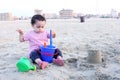 Arab baby girl playing with sand Royalty Free Stock Photo