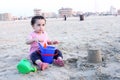 Arab baby girl playing with sand Royalty Free Stock Photo