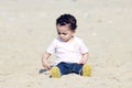 Arab baby girl playing with sand Royalty Free Stock Photo