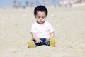 Arab baby girl playing with sand Royalty Free Stock Photo