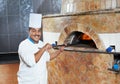 Arab baker chef making Pizza