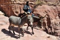 Arab bedouin guide riding in the ancient city of Petra, Jordan Royalty Free Stock Photo