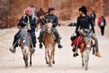 Arab bedouin guides riding in the ancient city of Petra, Jordan Royalty Free Stock Photo