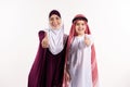 Arab boy and woman in hijab show thumbs up.