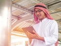 Arab business male useing on a tablet while traveling