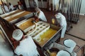 Arab business partners oversee cheese production in modern industry