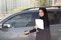 Arab Business Woman Standing next to a Car