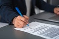 West eastern businessman hand sign a contract on the desk, closeup Royalty Free Stock Photo