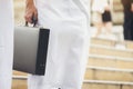 Arab businessman holding a briefcase walking up the stairs in th Royalty Free Stock Photo