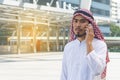 Arab businessman messaging on a mobile phone in the city