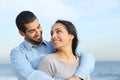 Arab casual couple cuddling happy with love on the beach