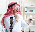 Arab chemist scientist testing quality of oil petrol Royalty Free Stock Photo