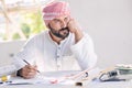 Arab construction architect, Muslim builder working at desk construction site design floor plan Royalty Free Stock Photo