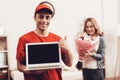Arab Deliveryman with Laptop and Girl with Flowers
