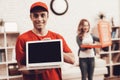 Arab Deliveryman with Laptop and Girl with Pizza. Royalty Free Stock Photo