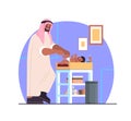 arab father changing diaper to his little son fatherhood parenting concept dad spending time with his baby at home Royalty Free Stock Photo