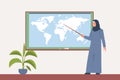 Arab female teacher in hijab stands with pointer near blackboard in her classroom. Earth map on black board, woman with