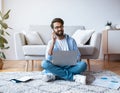Arab Freelancer Guy Using Laptop And Talking On Cellphone At Home Royalty Free Stock Photo
