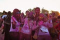 Arab friends, women wearing Hijabs and Ray-Bans, have crazy fun at the Color Walk in Dubai, United Arab Emirates.