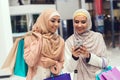 Young Arabian Women Using Smartphone on Shopping. Royalty Free Stock Photo