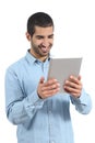 Arab happy casual man holding and reading a tablet reader