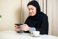 Arab happy casual woman using a smart phone at home