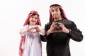 Arab happy father and son in ethnic clothes