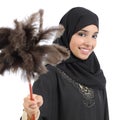 Arab housewife woman smiling and holding a duster clean