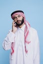 Arab looking away, speaking on phone
