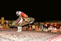 Arab male dancer performing in front of a crowd in Arabian deser