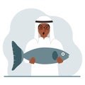 A arab male fisherman holds a large fish, proud of good fishing or hunting. Hobby, fishing concept. Royalty Free Stock Photo