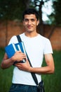 Arab male student with books outdoors